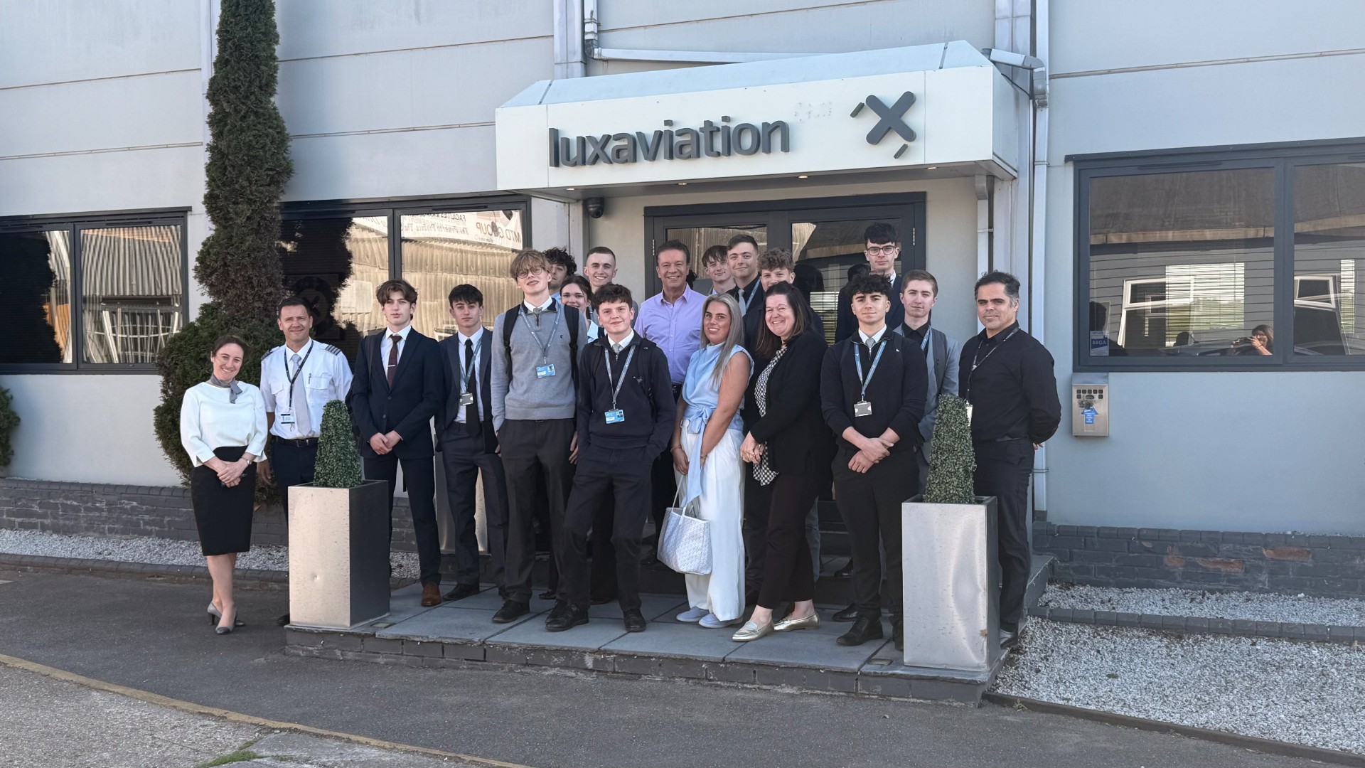 Luxaviation UK team and Stansted Airport College students outside the Luxaviation UK office during the company’s 30th anniversary celebrations